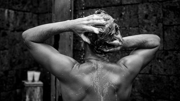 NNAW man washing hair with thickening shampoo